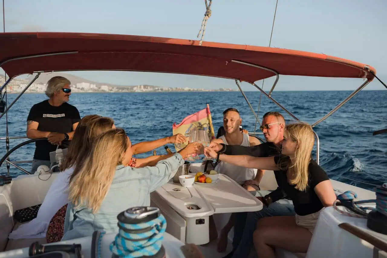 Passengers on the Atlantic Star raising glasses in a cheerful toast, celebrating their journey with smiles and sparkling drinks.