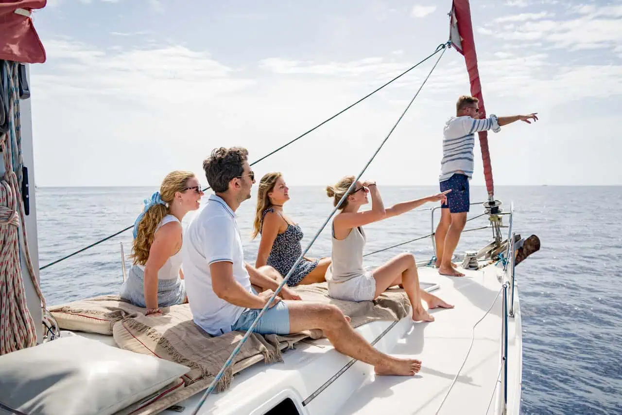 A relaxed group lounges on the deck of the Atlantic Star, enjoying each other's company and the calm sea breeze.