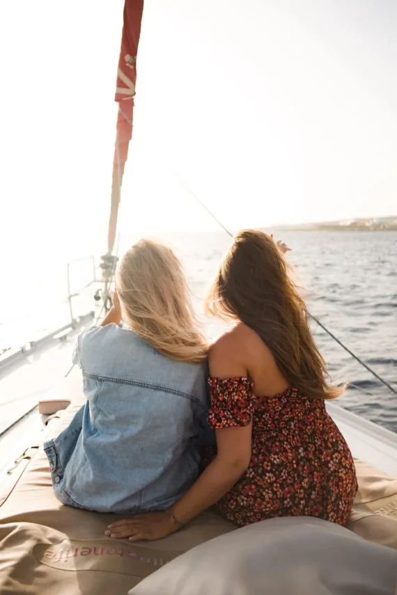 Two women enjoying a romantic sunset view during a boat cruise in Tenerife.