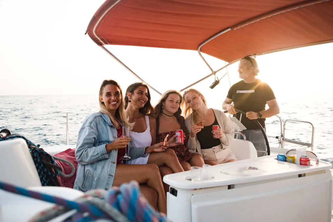 Happy small group enjoying a whale watching boat trip from Puerto Colón with the Atlantic Star captain at the wheel
